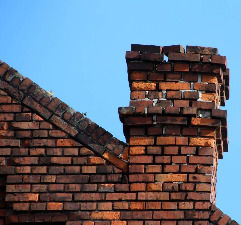Signs Your Chatham Home Needs a Chimney Inspection Damaged chimney on an Chatham home showing cracks and missing mortar